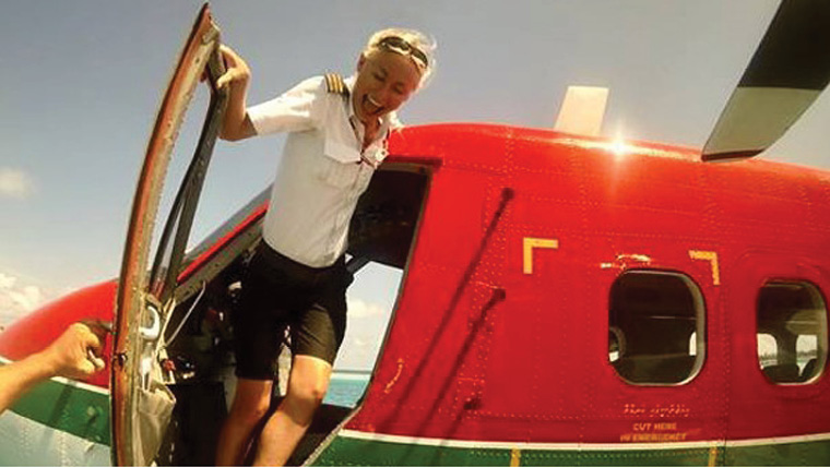 Pilot Maria Wiuff barefoot in plane